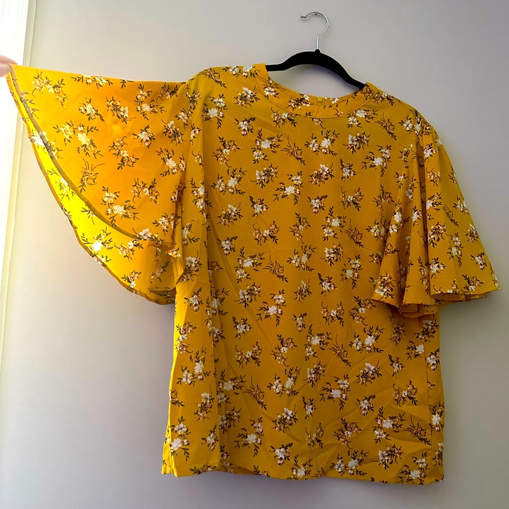 Marigold floral high neck top with flowy sleeves. Zip up back.